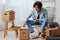 guy with curly hair sitting on a chair with boxes interior moving interior