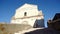 Guy dances on vintage stairs against historic church and sky