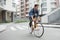 Guy in denim jacket goes to school on bike. Cyclists the road in the city