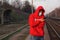 Guy in a disposable medical mask stands at the train station holding a telephone. outbreak of coronavirus flu epidemic covid-19.