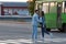 Guy escorts girl to bus, hugs and kisses. Couple in love saying goodbye at the bus stop