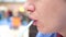 A guy in a fast food restaurant drinks a carbonated sweet drink through a tube. Mouth close up