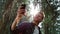 Guy fixing hairstyle before selfie on smartphone. Hiker taking selfie on phone