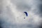 Guy flying on the clearly blue sky by paramotor red kite,extreme activity port.