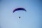 Guy flying on the clearly blue sky and wonderful beach by paramotor red kite,extreme activity port. feel freedom like birds.