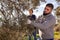 Guy gathering harvest in olive farm