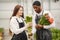 Guy with a girl in a greenhouse with tulips