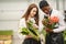 Guy with a girl in a greenhouse with tulips