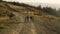 Guy and girl having walk with bicycles. Bicyclists looking around landscape