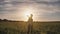 A guy and a girl launch a paralon plane at sunset.