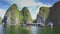 Guy and Girl Row Kayak near Floating House in Calm Bay