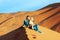 Guy and girl on the sand dunes in the Sahara Desert