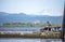 A guy and a girl are sitting on a bench on a floating dock on the Columbia River overlooking Mount Hood