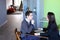 Guy and girl students relax in library after school and sit at t