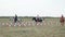 Guy and girls in traditional Cossack costumes on horseback