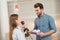 Guy gives his girlfriend a rose and gift. Girl is very happy with the gifts from the guy.