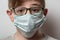 Guy with glasses and medical mask. Protection for influenza virus. Portrait child close up