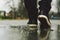 Guy goes in sneakers on the street in the rain