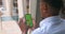 Guy hands using phone with mock up screen. Over shoulder view of afro american man touching and zooming phone green