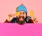 Guy with happy face wears warm hat on pink background