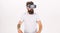 Guy with head mounted display interact in virtual reality. Hipster on strict face exploring virtual reality with modern