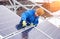 Guy with help of tools installs solar panels, snowy weather