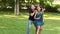 Guy helps the girl adjust to game. Game ring toss.