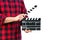 Guy is holding black clapperboard in handsisolated on white background