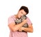 A guy holding a British cat in his arms and hugging her. emotional man isolated on white background