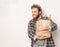 Guy is holding a paper bag with bottles of wine. Smiling he looks into camera. Concept of a good time, a friendly