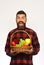 Guy holds homegrown harvest. Man with beard holds fruit basket