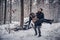 Guy from the last forces carries his girlfriend injured in an accident on a snowy road in the forest