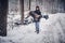 Guy from the last forces carries his girlfriend injured in an accident on a snowy road in the forest