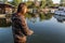 Guy with long brown hair fishing at river marine