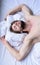 Guy macho lay white bedclothes. Man sleepy unshaven bearded face sleep has rest. Pleasant dream concept. Let your