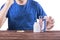 A guy with a migraine. Suicide prevention. A man taking meds isolated on a white background. A sick male in a blue t-shirt.