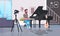 Guy musical blogger recording video on camera man playing classical piano music blog concept modern apartment interior