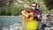 Guy plays on a guitar sings song sitting by mountain river on sunny day