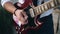 Guy plays guitar standing on the dock. Close-up of hands.