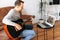 Guy plays guitar to parents via video call