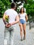 Guy prepared surprise bouquet for girlfriend. Gentlemans manners. Couple meeting for date park background. Bouquet