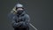 Guy protestor in black clothes, helmet, mask with protest sign stop it poses and leaves picket on gray background