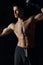 guy with a pumped-up torso gesturing with his hands on a black background boxing gloves