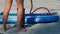 Guy pumps fast paddle board through pipe low-angle shot