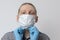 Guy puts on respiratory mask. Attractive man puts on face mask and looks at camera. Cold, flu, virus, tonsillitis, acute