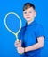 Guy with racket enjoy game. Future champion. Dreaming about sport career. Athlete kid tennis racket on blue background