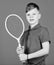 Guy with racket enjoy game. Future champion. Dreaming about sport career. Athlete kid tennis racket on blue background