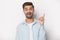 Guy raised finger up gesture of resourceful person studio shot