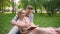 Guy reading book to his girlfriend, couple enjoying leisure in park together