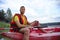 Guy in a red kayak floats down the river,